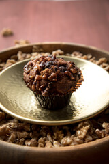 Walnuss Muffin in gold Messing Metall und Holz Schale mit Nüsse auf Holz Tisch Hintergrund