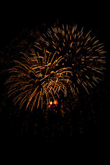 Holiday Fireworks at New Year Eve. Abstract Festive background with fireworks sparkles. Copyspace.