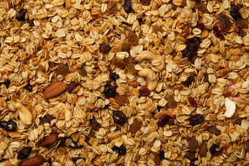 Granola with nuts and raisins on whole background