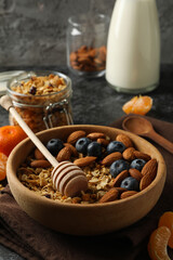 Concept of tasty breakfast with granola on black smokey background