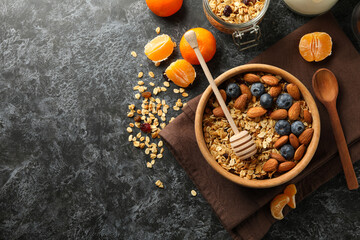 Concept of tasty breakfast with granola on black smokey background
