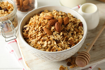 Concept of tasty breakfast with granola on white wooden background