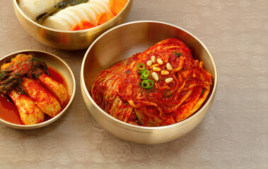 The most famous Korean food Kimchi set(napa cabbage, whole radish, radish water ) in high quality brass tableware. Top view. 
