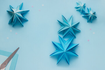 Simple origami 3D Christmas tree made from blue paper. Step by step instruction, step 17. Use next...