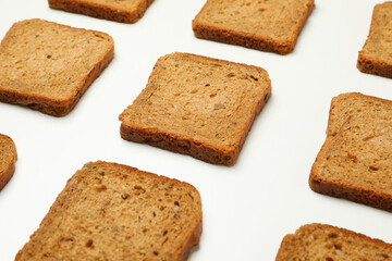 Flat lay with dark bread slices on white background