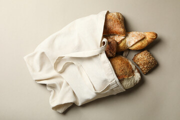 Cotton bag with bakery products on gray background