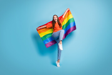 Full length photo of cheerful girl dressed red t-shirt standing one leg open moth lgbt flag hands...