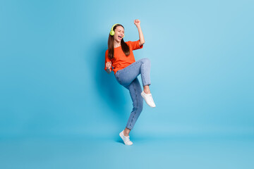 Profile photo of attractive shiny lady dressed orange t-shirt dancing listening mp3 player isolated...