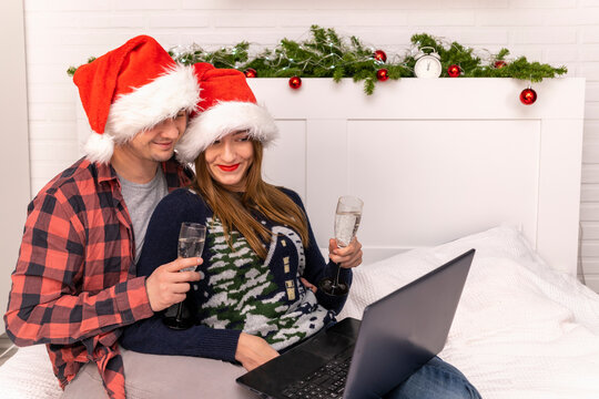 Online remote congratulations Happy married couple drinks champagne for Christmas Family New Year quarantine covid 19 pandemic Place text Copy space