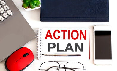 Action plan memo written on a notebook with laptop