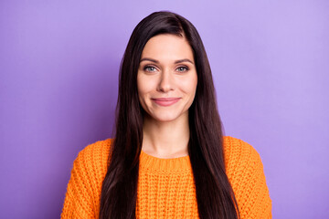 Photo portrait of brunette with long hair smiling in orange sweater isolated on vibrant purple...