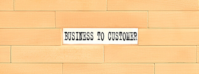 BUSINESS TO CUSTOMER text on the wooden block wall, business