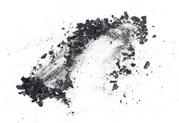 Black dust powder of charcoal on a white background, top view. Charcoal dust with fragments.