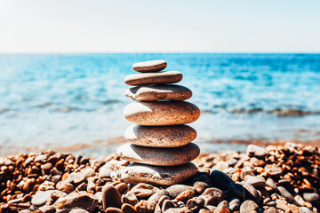 Fototapeta na wymiar Balancing stones on the beach - oriental medicine - a symbol of delicate balance