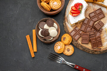 top view cake slices with cookies and chocolate on dark background biscuits fruit sweet