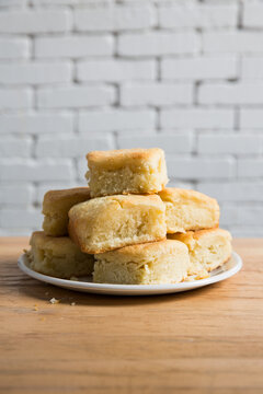 Plate with buttermilk biscuits over wood surface.