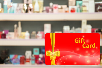 Store gift card. Blurred view of shelves with perfume bottles in shop