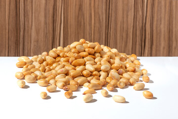 peeled peanuts on wooden background ( wooden background )