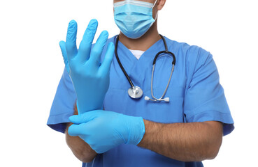 Doctor in protective mask putting on medical gloves against white background, closeup
