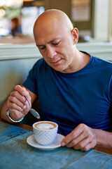 Man in a cafe at breakfast.