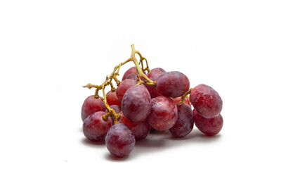 Close up a bunch of fresh red grapes on isolated white background.