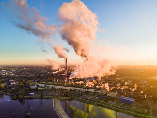 Pipes of an industrial enterprise. Emissions of smoke into the atmosphere and Pollution. Sky at sunrise