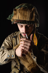 World War II, American 101 Airborne soldier wearing a m42 uniform and lightening cigarette....
