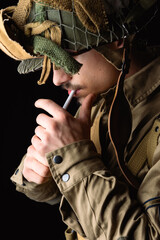 World War II, American 101 Airborne soldier wearing a m42 uniform and lightening cigarette....