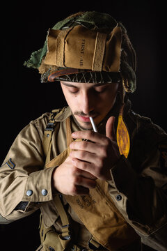 World War II, American 101 Airborne soldier wearing a m42 uniform and lightening cigarette. (506pri). E company, D-day invasion 44.