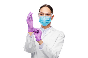 science, health and medicine concept - young female doctor or scientist wearing gloves, goggles and face protective medical mask for protection from virus