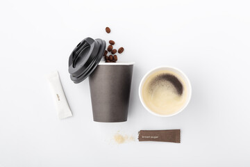 Obraz na płótnie Canvas Coffee in black paper cup with sugar
