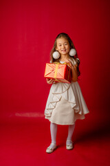 little asian girl new year on red background holding a gift