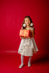 little asian girl new year on red background holding a gift