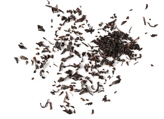 Dry black tea leaves pile isolated on white background, top view