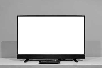 Flat LCD television on wood table in the living room with dark gray wall