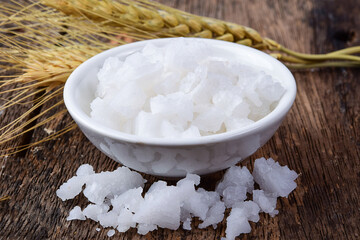 Salt cubes in white bowl on wooden