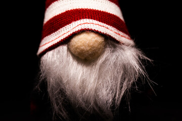 Christmas gnome or elf. Festive decoration on black background.