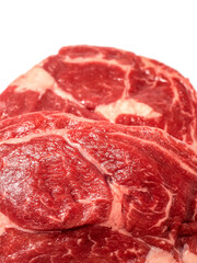 Fresh raw rib eye steak on white isolated surface. Meat industry product. Premium tender meat cut. Close up