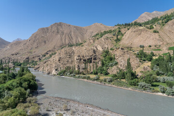 Landscape view of Panj river valley, border between Tajikistan and Afghanistan near Khorog in mountainous Gorno-Badakshan the Pamir region of Tajikistan