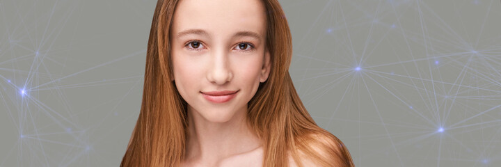 Fototapeta premium Cosmetology concept. Skin care product. Female portrait. Face mask. Home peeling. Grey background. Copyspace. Facial lifting treatment. Dermatology beauty model. Young girl. Technology