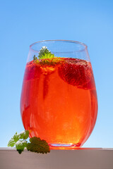 Summer refreshing cocktail with strawberries, ice and fresh mint leaves.
