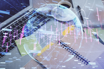 Multi exposure of forex graph drawing and desktop with coffee and items on table background. Concept of financial market trading