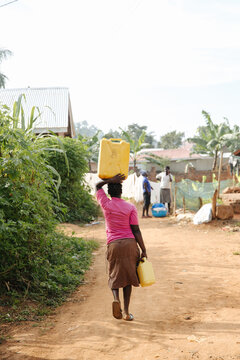 Woman carrying water in Uganda, Africa