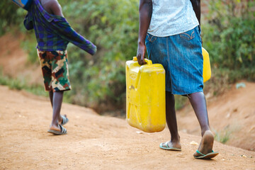 Woman carrying water in Uganda, Africa