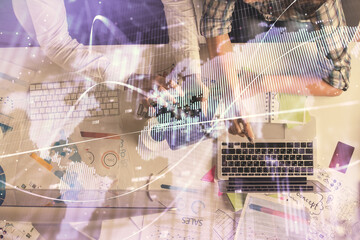Double exposure of man and woman working together and financial graph hologram drawing. market analysis concept. Computer background. Top View.