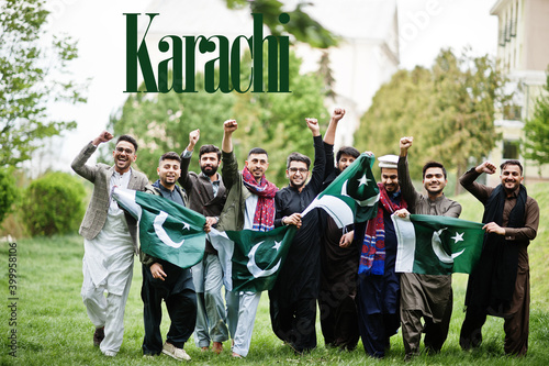 Karachi city. Group of pakistani man wearing traditional clothes with national flags. Biggest cities of Pakistan concept.