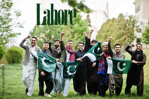 Lahore city. Group of pakistani man wearing traditional clothes with national flags. Biggest cities of Pakistan concept.