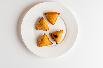 Samosas. Indian samosas. Fried dough patty filled with seasoned meats, rice, and vegetables. Classic Indian appetizer.