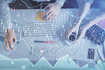 Double exposure of man and woman working together and financial chart hologram drawing. market analysis concept. Computer background. Top View.