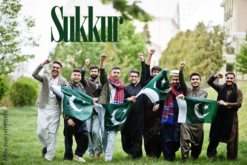 Sukkur city. Group of pakistani man wearing traditional clothes with national flags. Biggest cities of Pakistan concept.